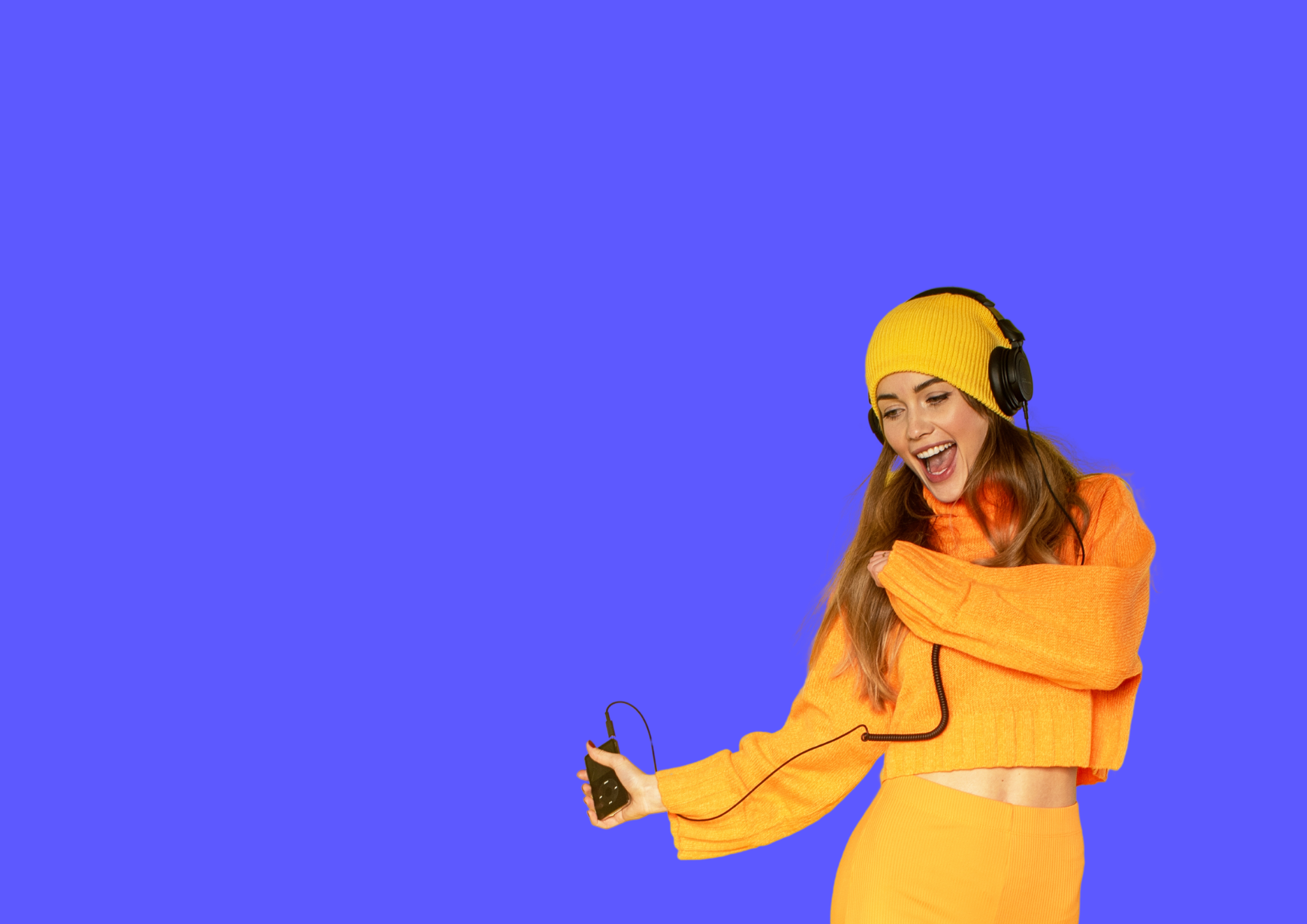 Woman in orange outfit is dancing to music. Blue background.