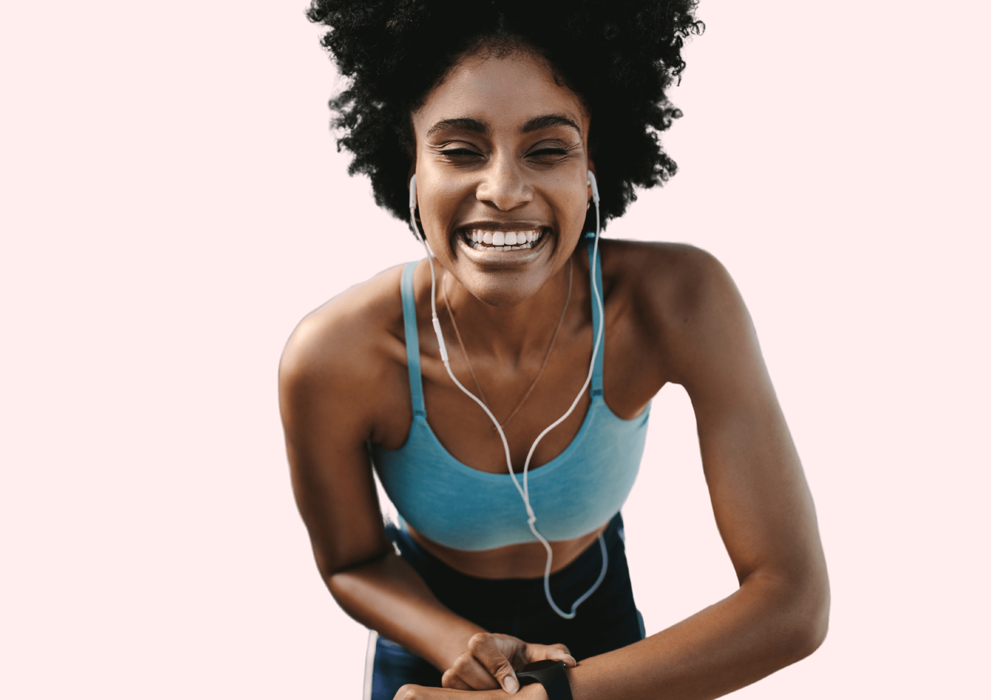 Sporty woman smiles while listening music during workout.