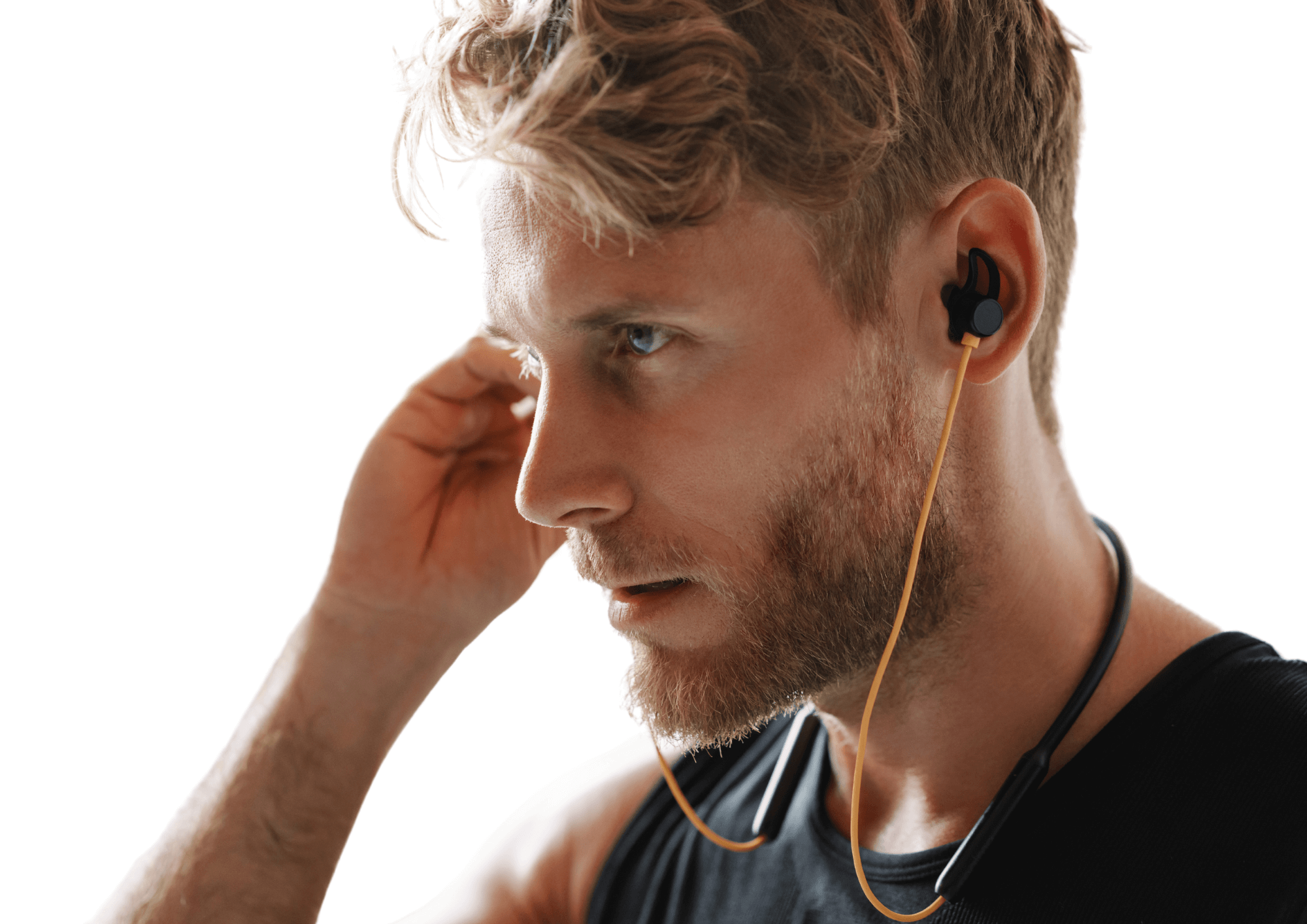 Man is listening to music on his headphones as he focuses on training. White background.