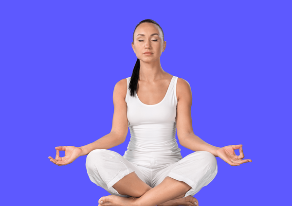 Woman in white sports clothes practices MBSR meditation.