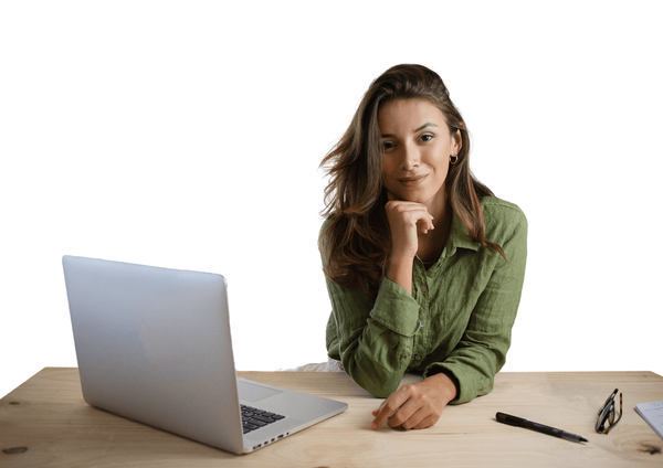 Young woman smiling while sitting at her laptop.